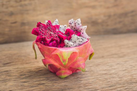 Pieces of sliced dragon fruit in the form of a star on an old withered background.