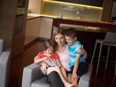 Happy Family Lying Down On The Sofa And Using Tablet