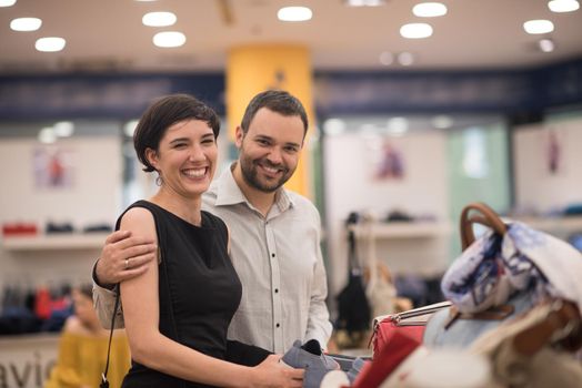 A young attractive couple changes the look with new shoes  At Shoe Store