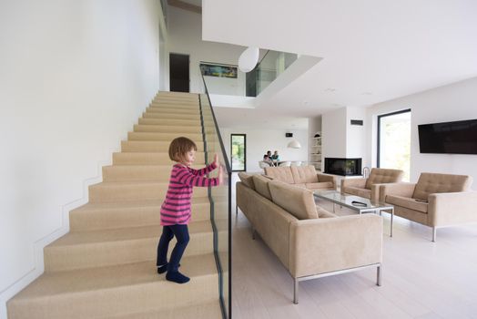 happy young family with little girl enjoys in the modern living room of their luxury home villa