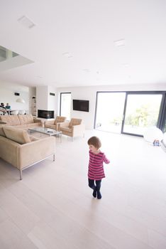 happy young family with little girl enjoys in the modern living room of their luxury home villa