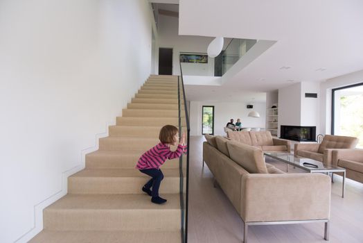 happy young family with little girl enjoys in the modern living room of their luxury home villa