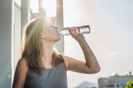 Portrait of Beauty Red-haired woman with eye patches drinks water. Spa Girl.