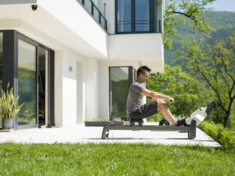 young handsome man doing morning exercises in front of his luxury home villa