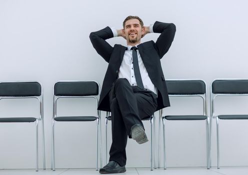 dreaming of a businessman sitting in an office corridor.photo with copy space