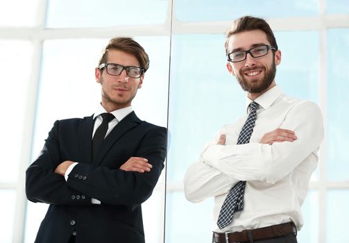 bottom view.two confident businessman standing in the office .business concept