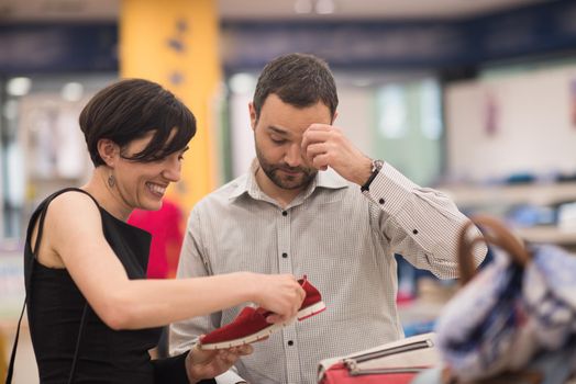 A young attractive couple changes the look with new shoes  At Shoe Store