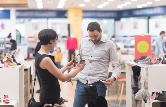 A young attractive couple changes the look with new shoes  At Shoe Store