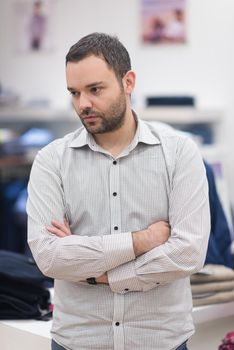 Portrait of an attractive man Shopping In A Man's Clothing Store