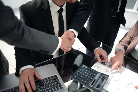 closeup, businessman handshaking after conference.