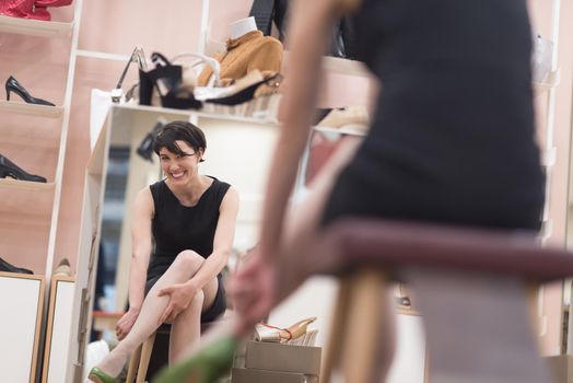 Woman Chooses  Shoes At Fashionable Shop