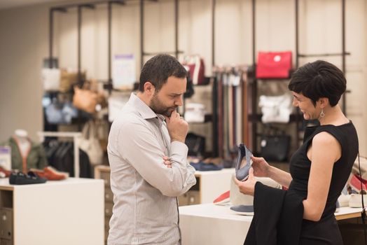 A young attractive couple changes the look with new shoes  At Shoe Store