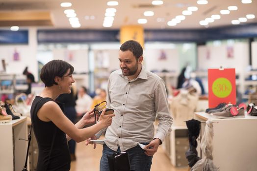 A young attractive couple changes the look with new shoes  At Shoe Store