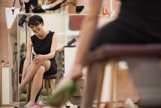 Woman Chooses  Shoes At Fashionable Shop