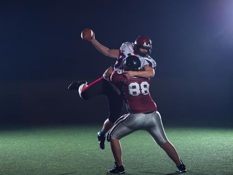 American football players in action at night game time on the field