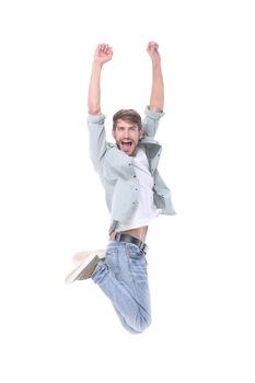 in full growth. Cheerful handsome man jumps for joy. isolated on white background