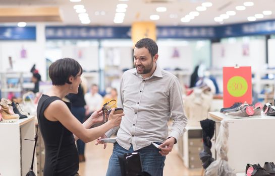 A young attractive couple changes the look with new shoes  At Shoe Store