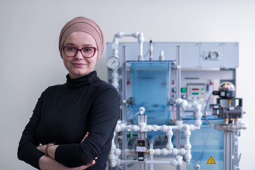 portrait of a young female muslim student standing in the electronic classroom, Education and technology concept