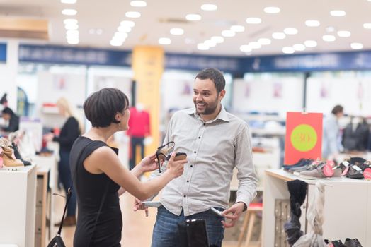 A young attractive couple changes the look with new shoes  At Shoe Store