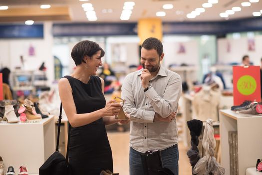 A young attractive couple changes the look with new shoes  At Shoe Store