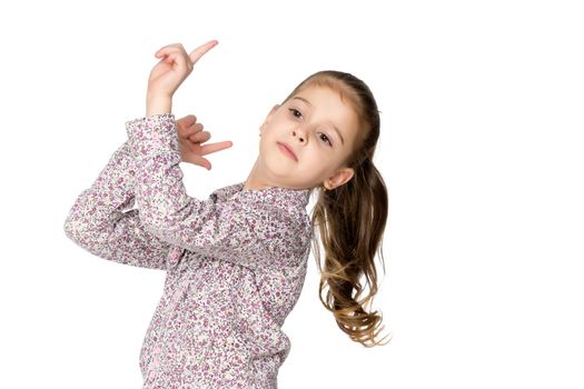 The little girl points with her finger. The concept of play and happy childhood. Isolated on white background.