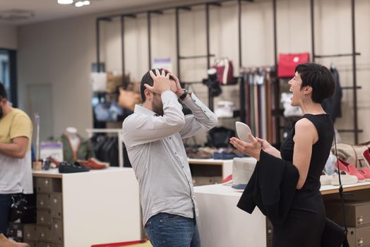 A young attractive couple changes the look with new shoes  At Shoe Store