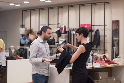 A young attractive couple changes the look with new shoes  At Shoe Store