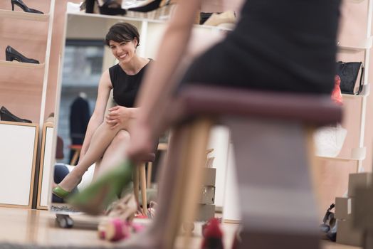 Woman Chooses  Shoes At Fashionable Shop