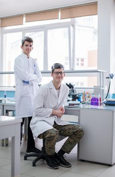 Group of young medical students doing research together in chemistry laboratory,teamwork by college student indoors