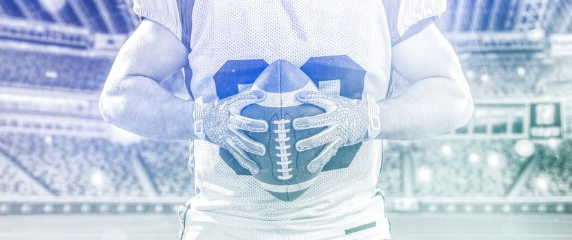 Closeup Portrait of a strong muscular American Football Player on big modern stadium field with lights and flares