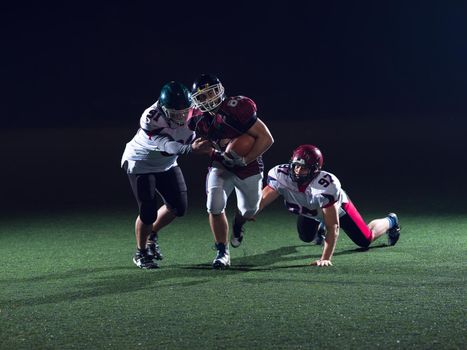 American football players in action at night game time on the field