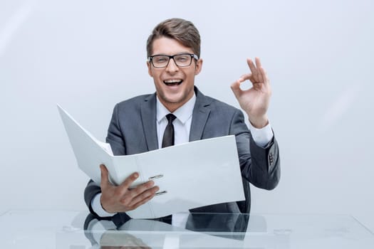 close up. businessman with clipboard showing OK gesture, business concept