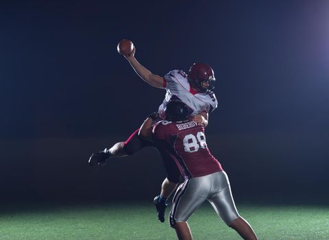 American football players in action at night game time on the field