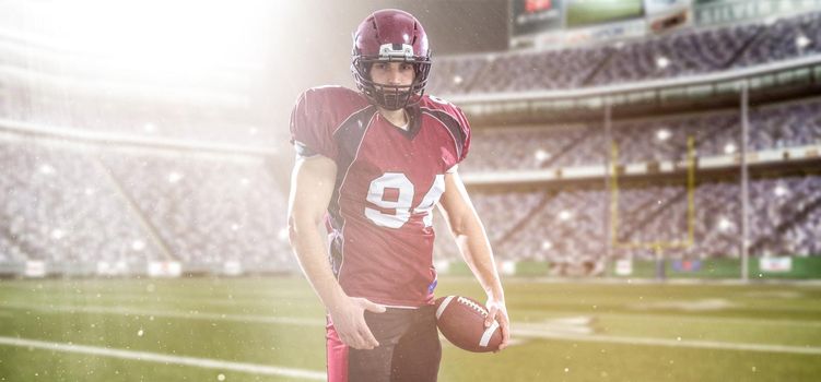 American Football Player isolated on big modern stadium field with lights and flares