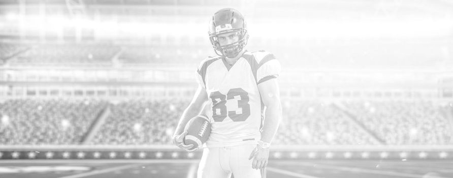 American Football Player isolated on big modern stadium field with lights and flares