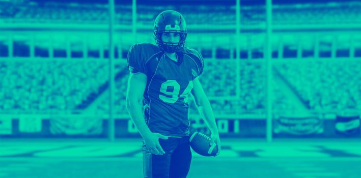 American Football Player isolated on big modern stadium field with lights and flares