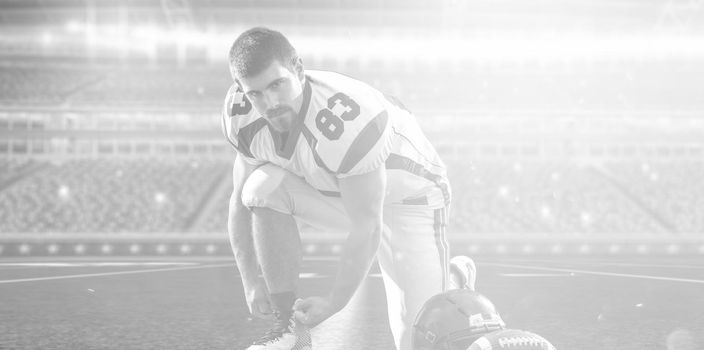 American Football Player preparing for match on big modern stadium field with lights and flares