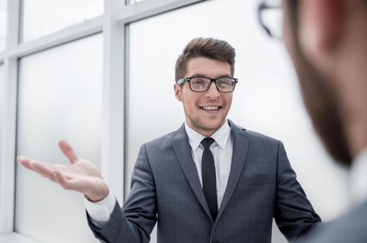 young businessman talking standing in the office.business concept