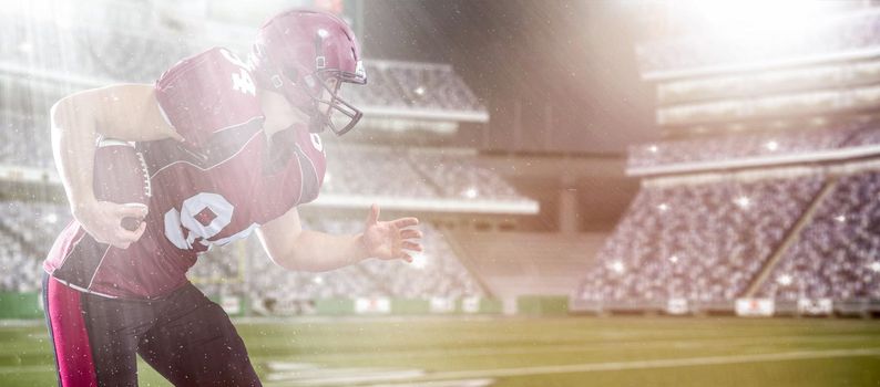 American football Player running with the ball isolated on big modern stadium field with lights and flares