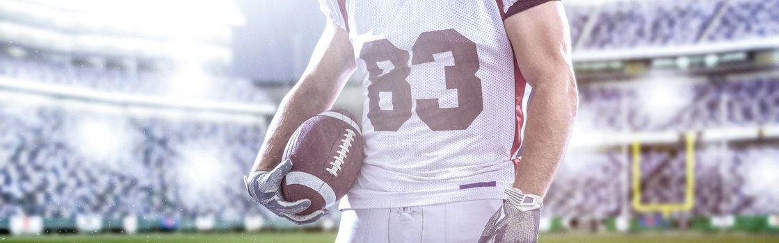 Closeup Portrait of a strong muscular American Football Player on big modern stadium field with lights and flares