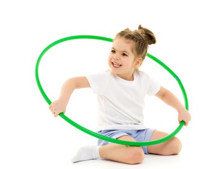 Beautiful little girl in a pure white T-shirt, on which you can write a logo or any other text that plays with a hoop. The concept of advertising, children's sports. Isolated on white background