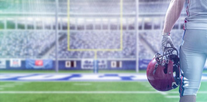 Closeup Portrait of a strong muscular American Football Player on big modern stadium field with lights and flares