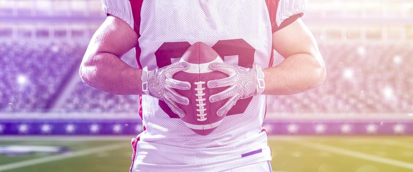 Closeup Portrait of a strong muscular American Football Player on big modern stadium field with lights and flares