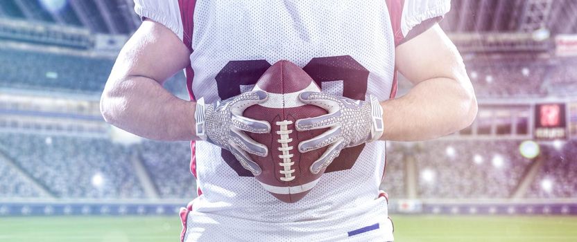 Closeup Portrait of a strong muscular American Football Player on big modern stadium field with lights and flares