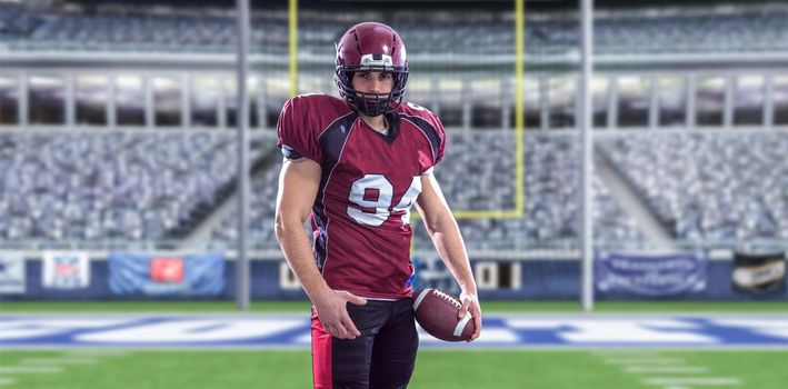 American Football Player isolated on big modern stadium field with lights and flares