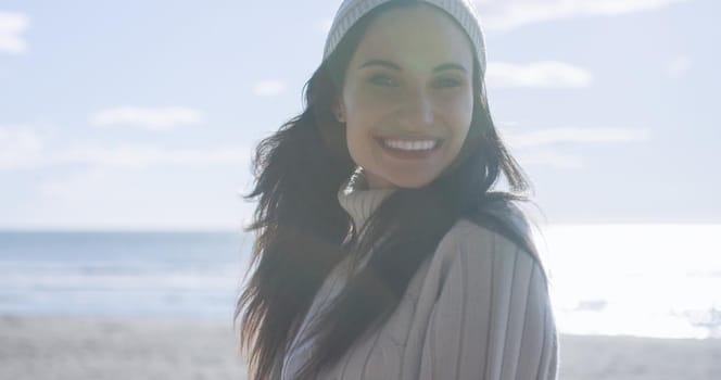 Portrait Of A Young Woman In Autumn Clothes Smiling On The Beach