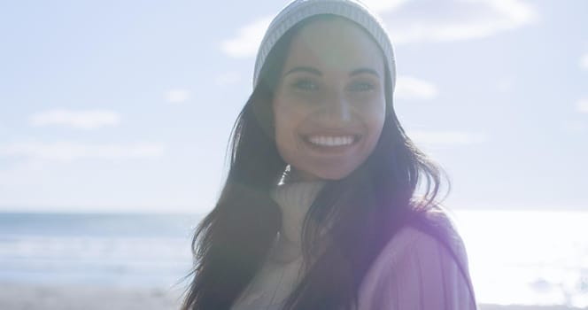 Portrait Of A Young Woman In Autumn Clothes Smiling On The Beach