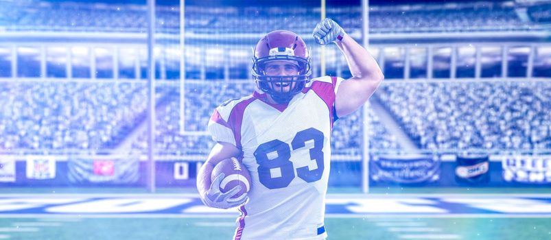 american football player celebrating touchdown on big modern stadium field with lights and flares