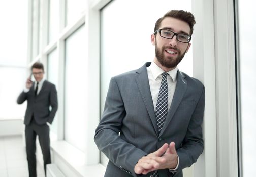 pensive businessman standing in the hallway of the office.photo with copy space