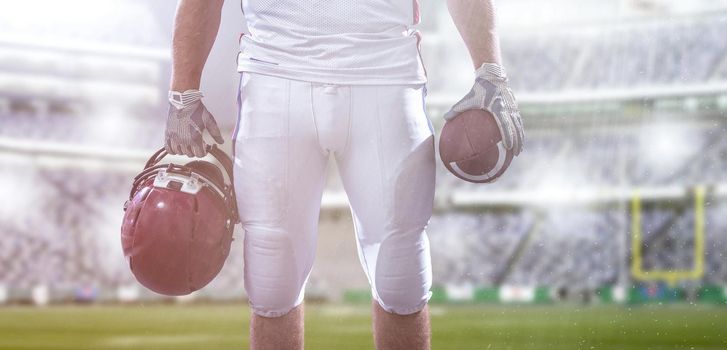 Closeup Portrait of a strong muscular American Football Player on big modern stadium field with lights and flares